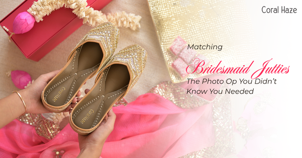 Gold glittery flats held by a hand with a pink and gold decorative background